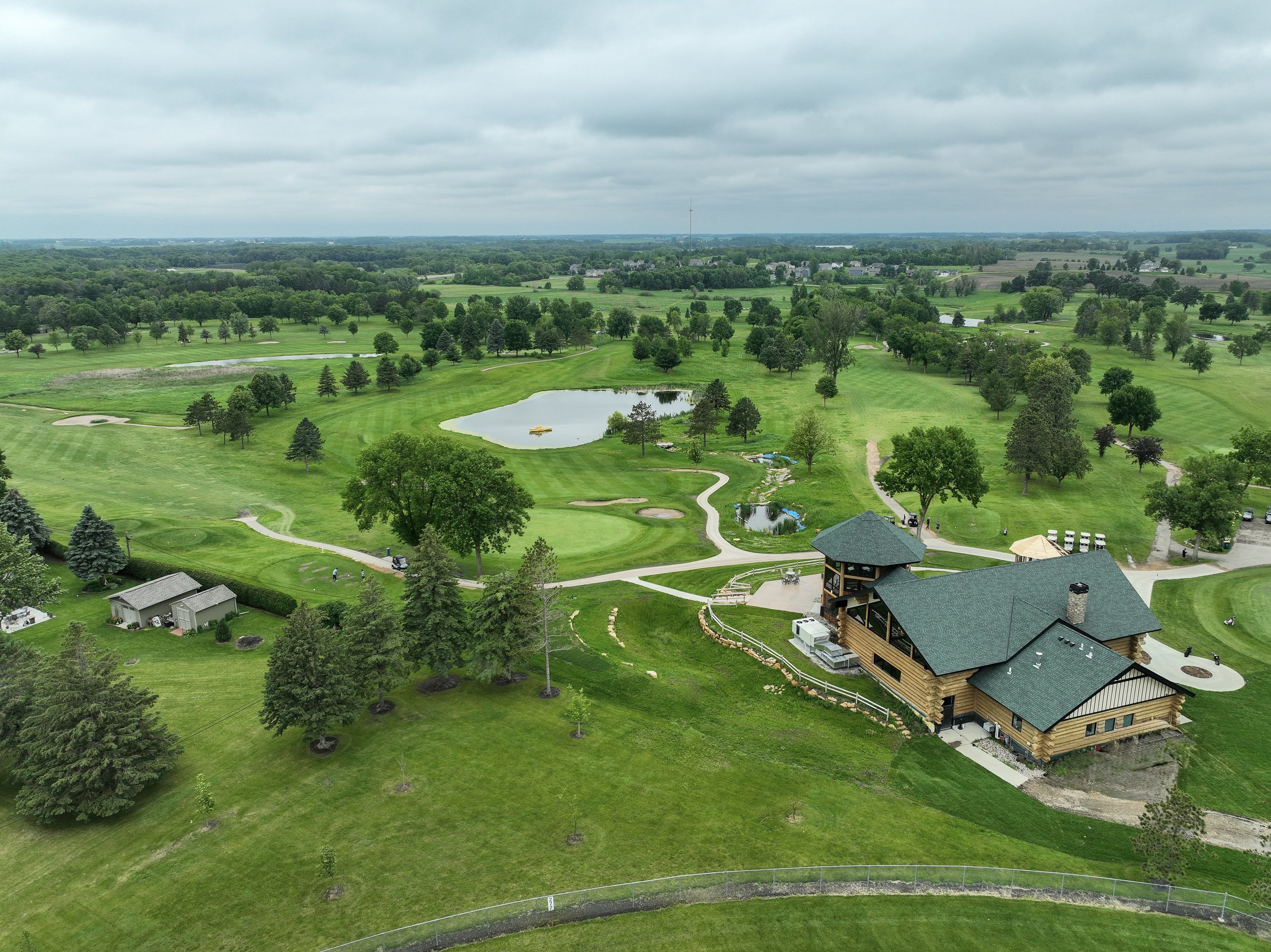 Drone view over the course, its ponds and the log cabin clubhouse at Montgomery National Golf Club